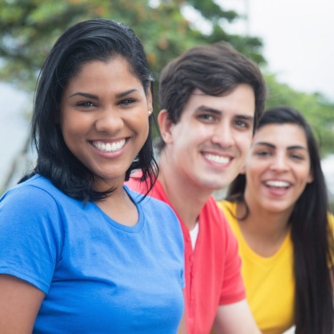 Beautiful latin woman in a blue shirt with caucasian man and native friend Beautiful latin woman in a blue shirt with caucasian man and native friend outdoor in the city